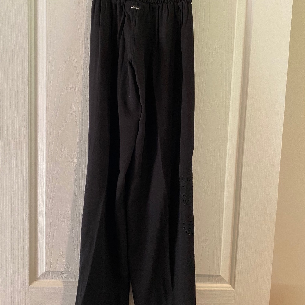 Black pants with pretty cutout detail on pant leg